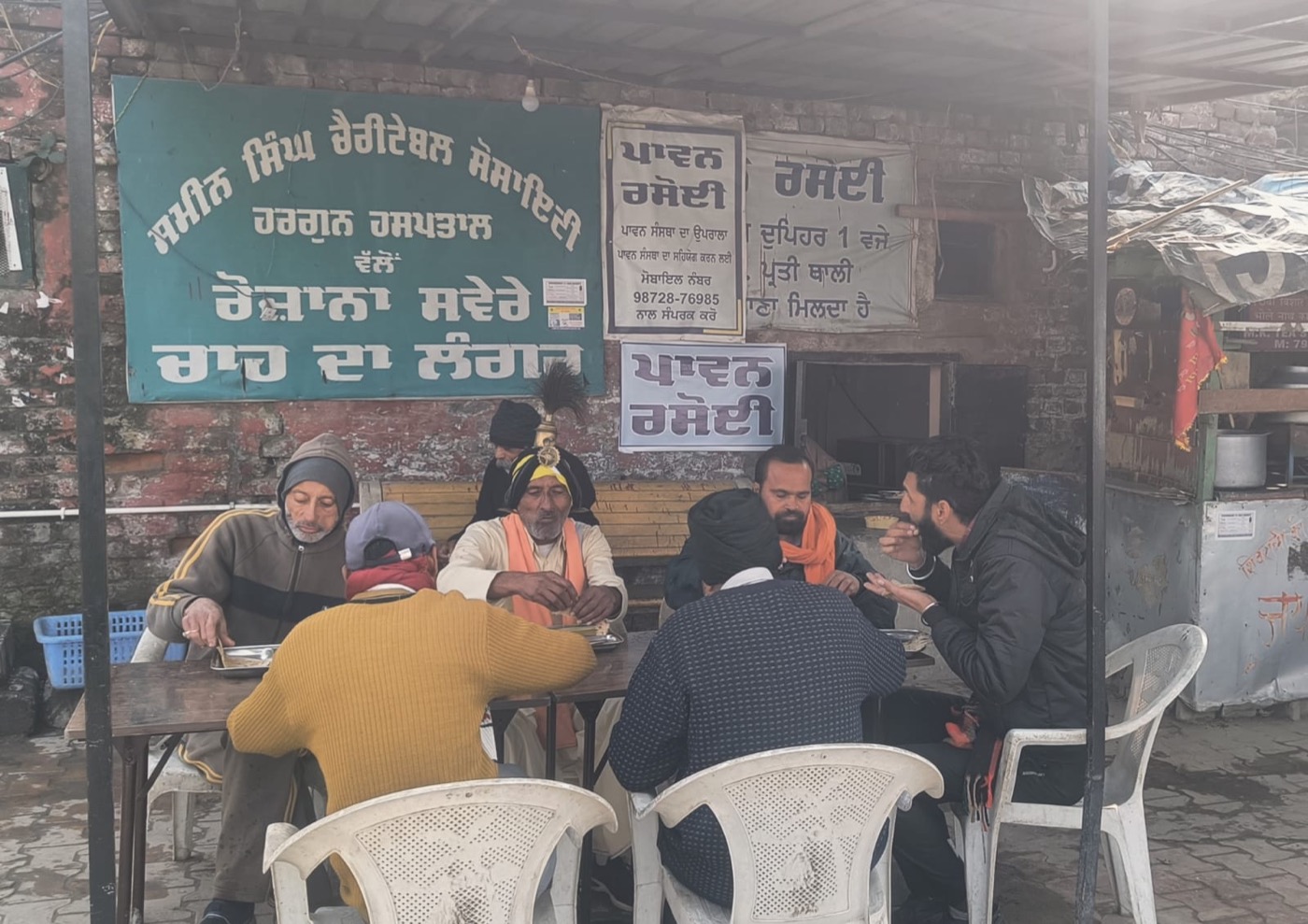Beneficiaries seated together, sharing a meal