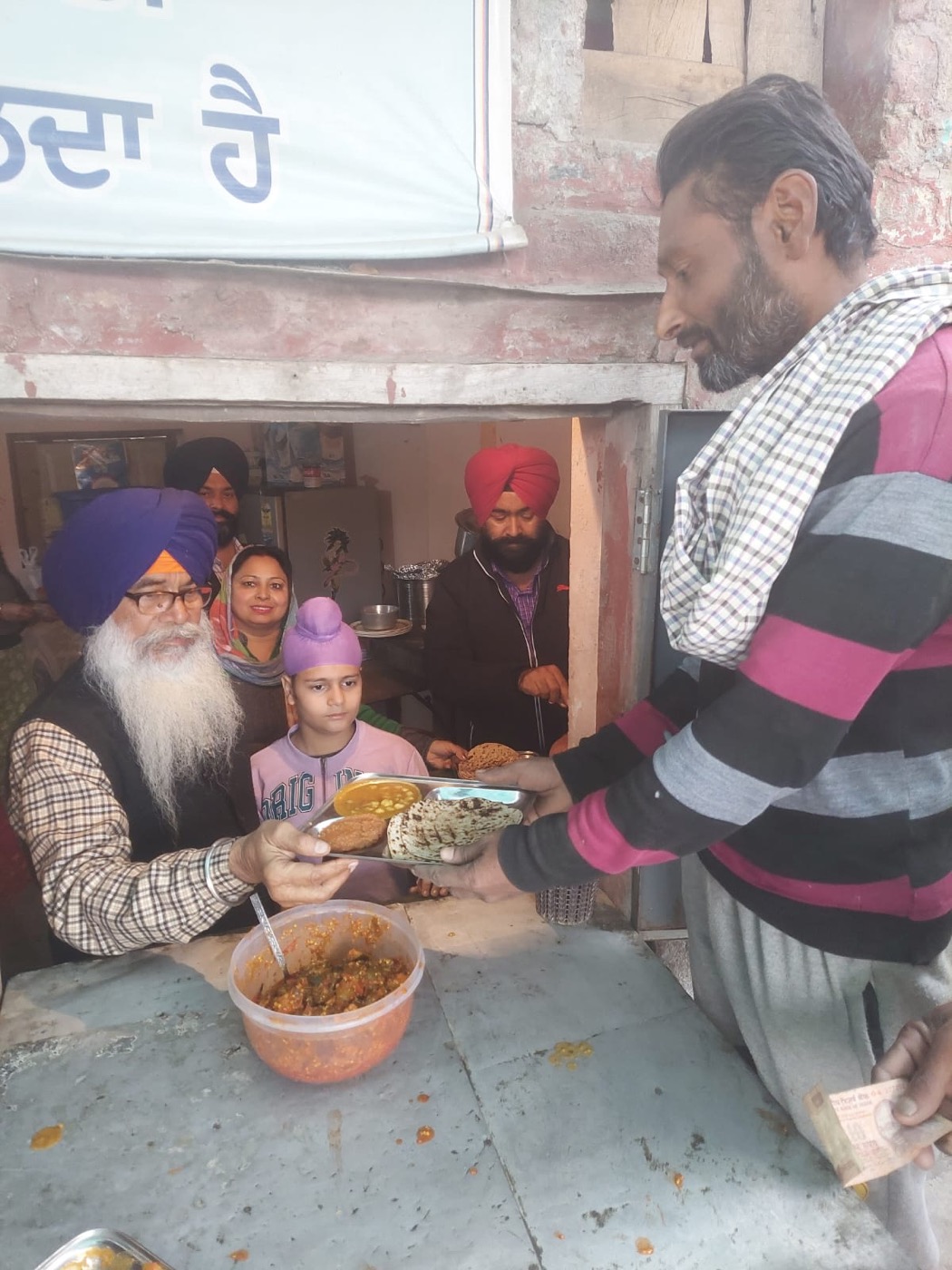 A tray of food being handed to a family
