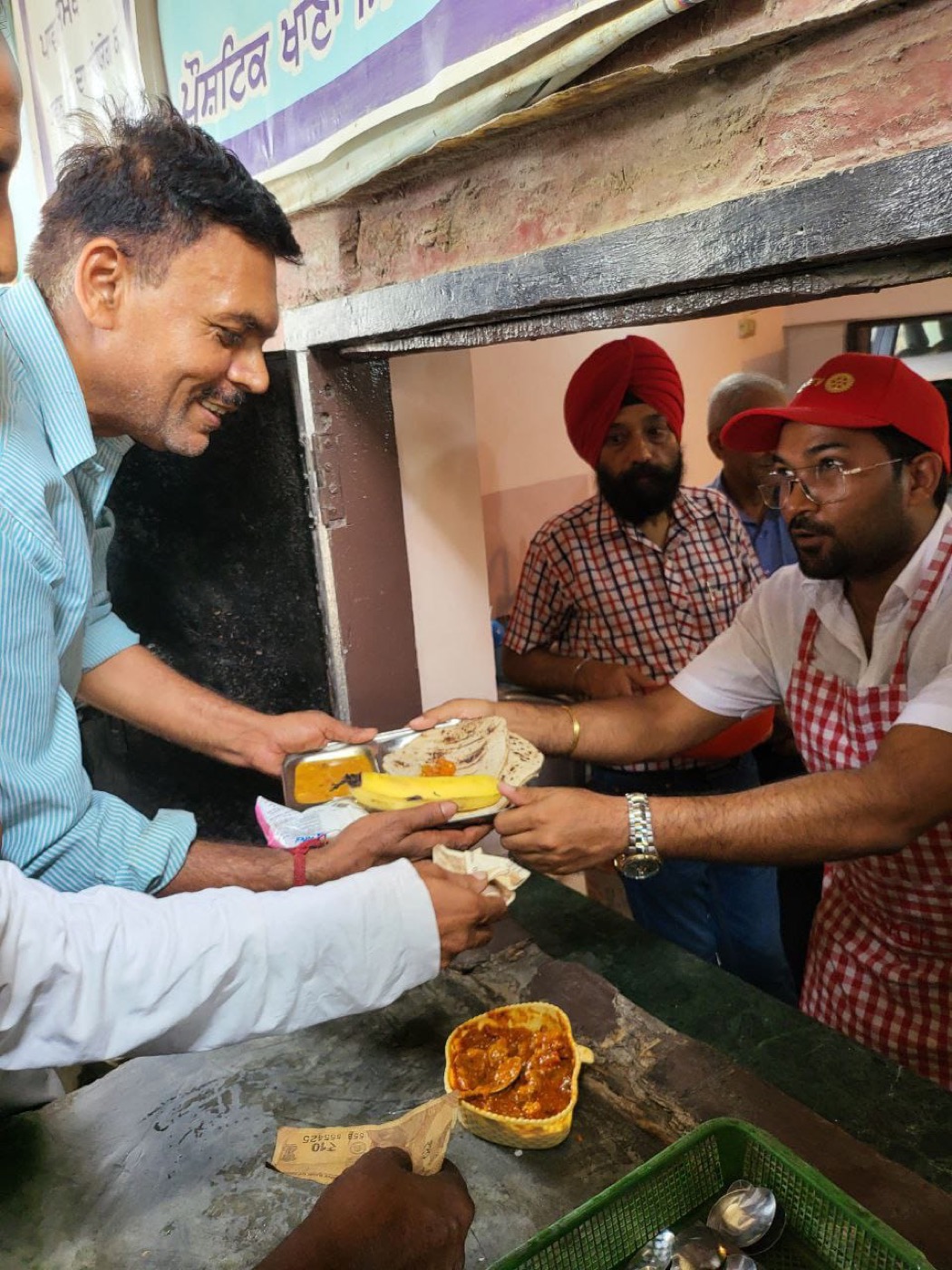 A tray of food with roti and banana being served